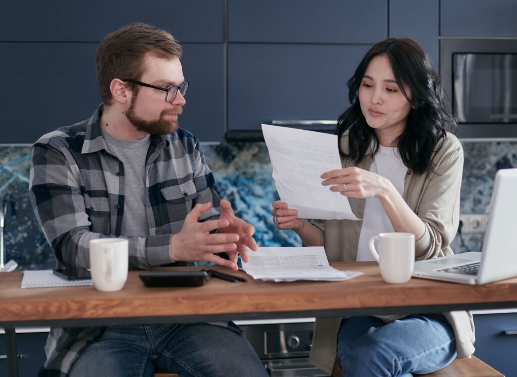 Pareja joven revisando ayudas y documentación económica en España en 2026